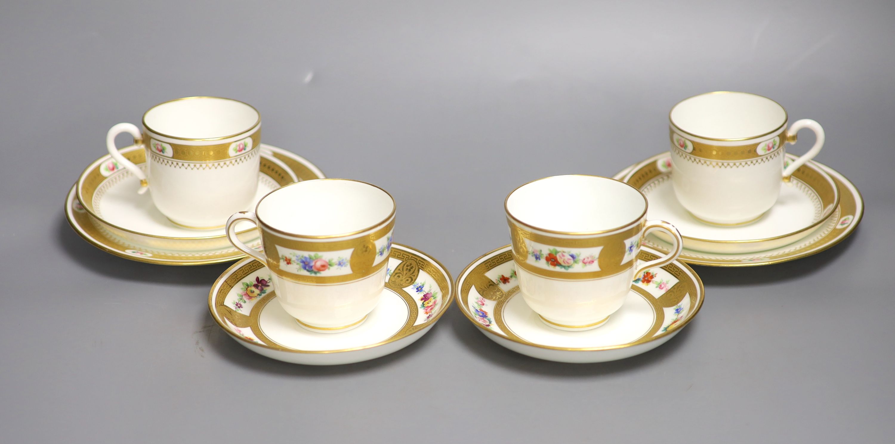 A pair of Minton coffee cups and saucers & pair Minton trios